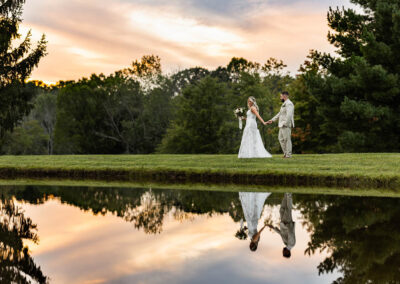 bride and groom by lake