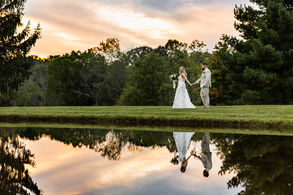 bride and groom by lake